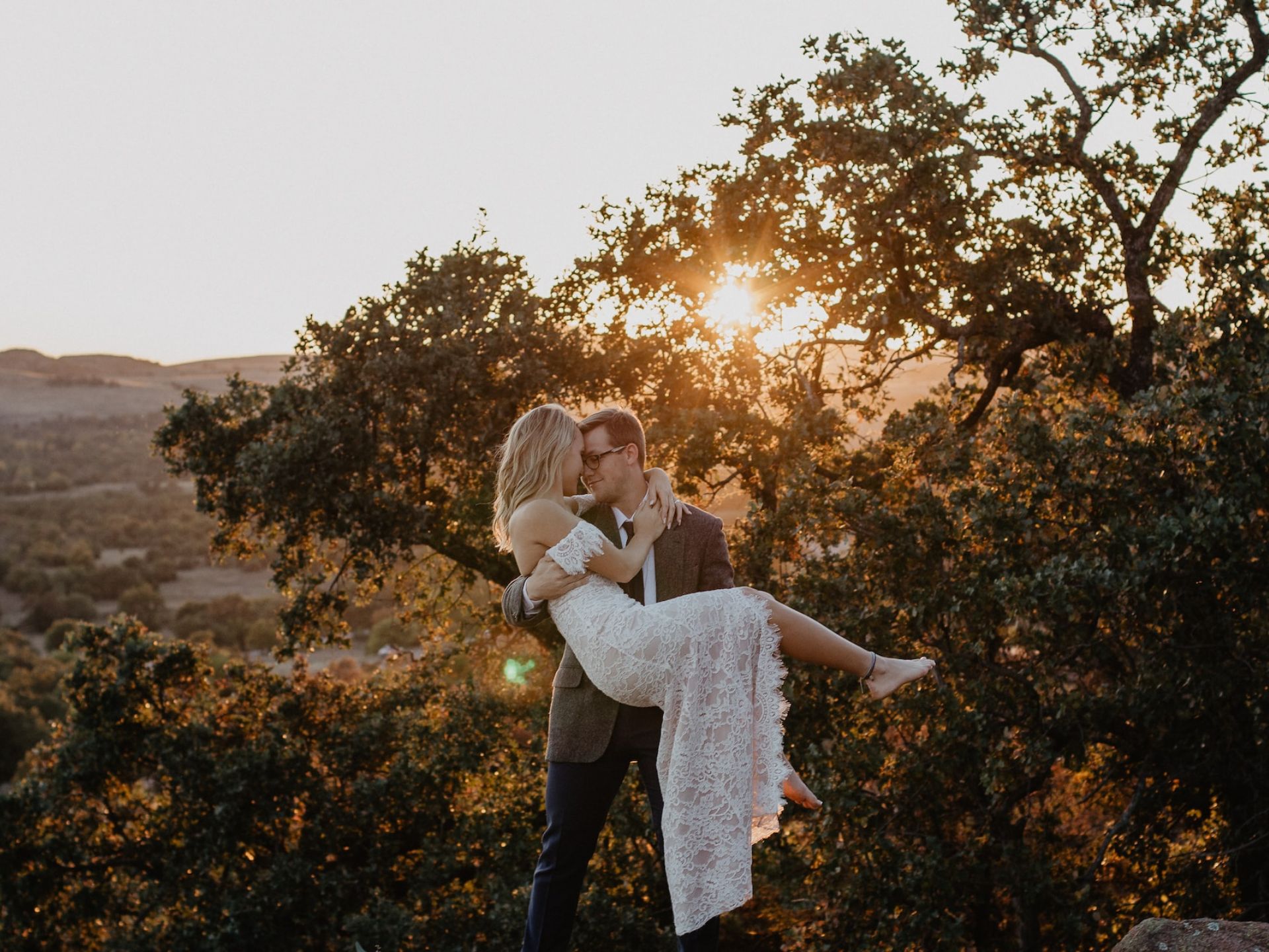 A bride and groom under the sunset.
