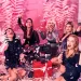 A group of girls with a bunch of gift boxes.