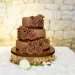 A table with a chocolate wedding cake.