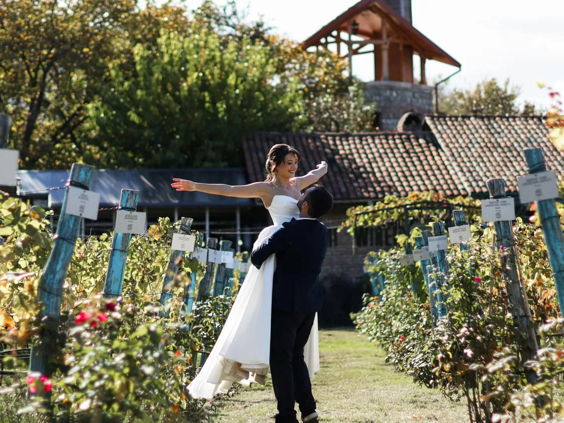 A bride and groom at a vineyard themed wedding.