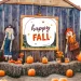 A pumpkin patch with scarecrows and hay bales.