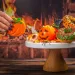 A women platting halloween decorated cookies.