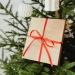 A christmas tree with a gold and red christmas present.