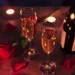 A table with champagne and roses.