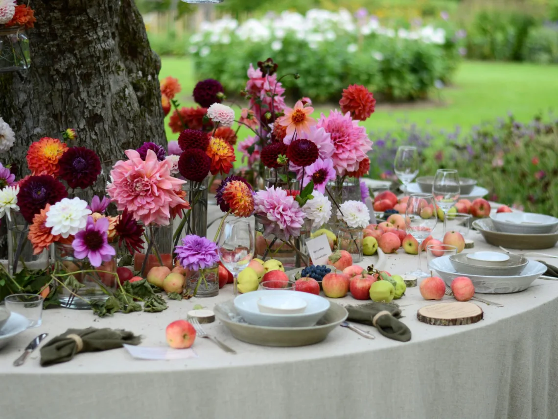 A wedding table with bright pink and purple wildflowers.
