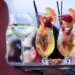 A woman carrying a tray of fruit wedding cocktails.