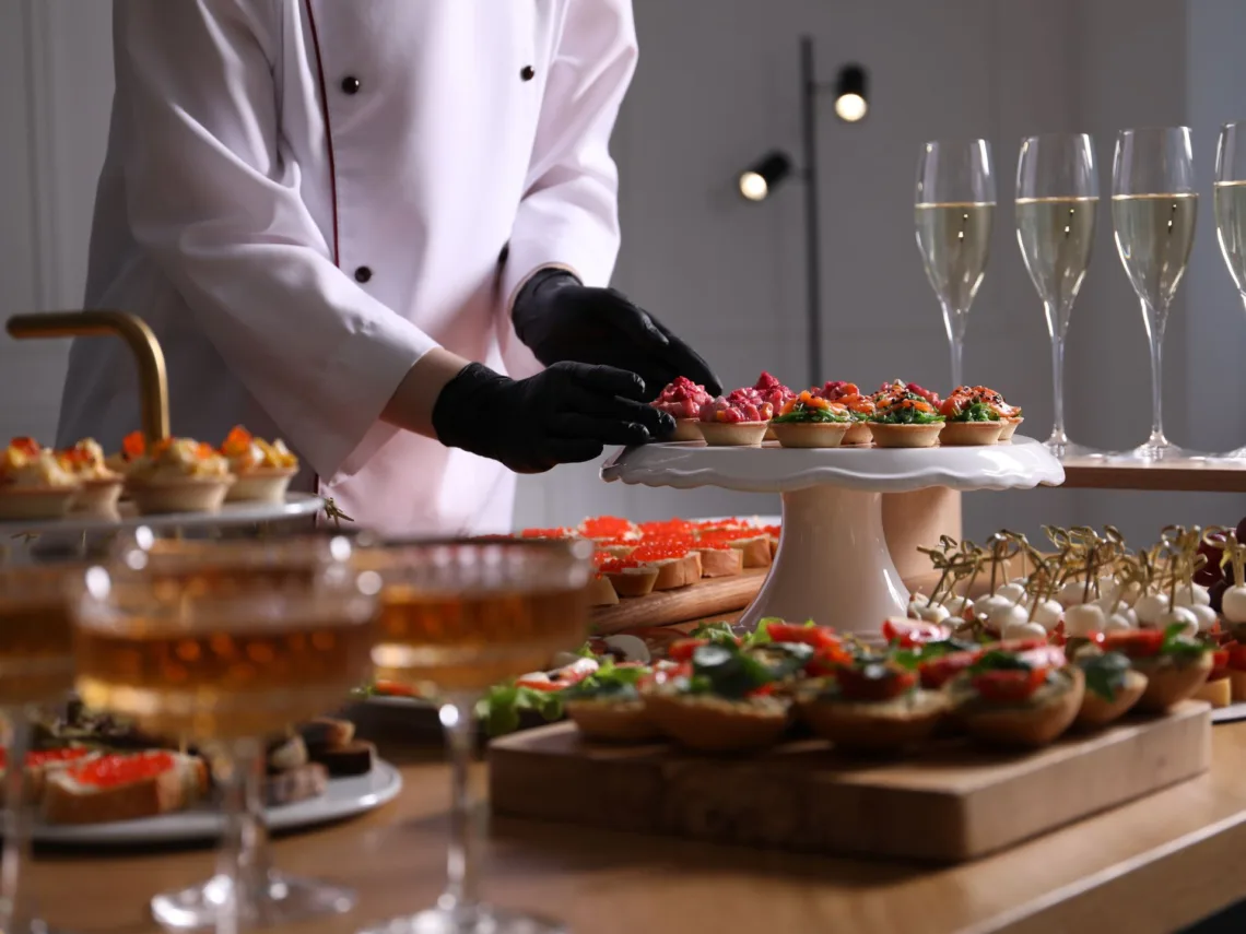 A wedding table with mini wedding foods for cocktail hour.