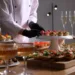 A wedding table with mini wedding foods for cocktail hour.