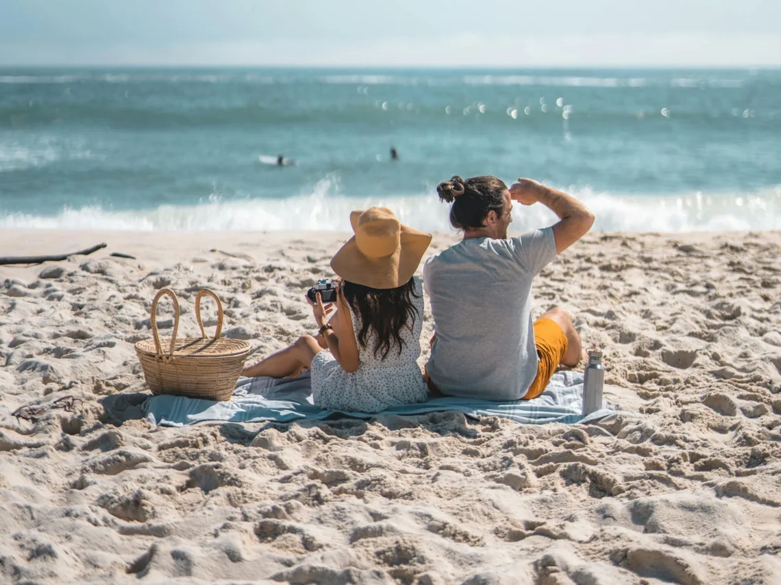A couple having a picnic on the beach.