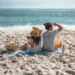 A couple having a picnic on the beach.