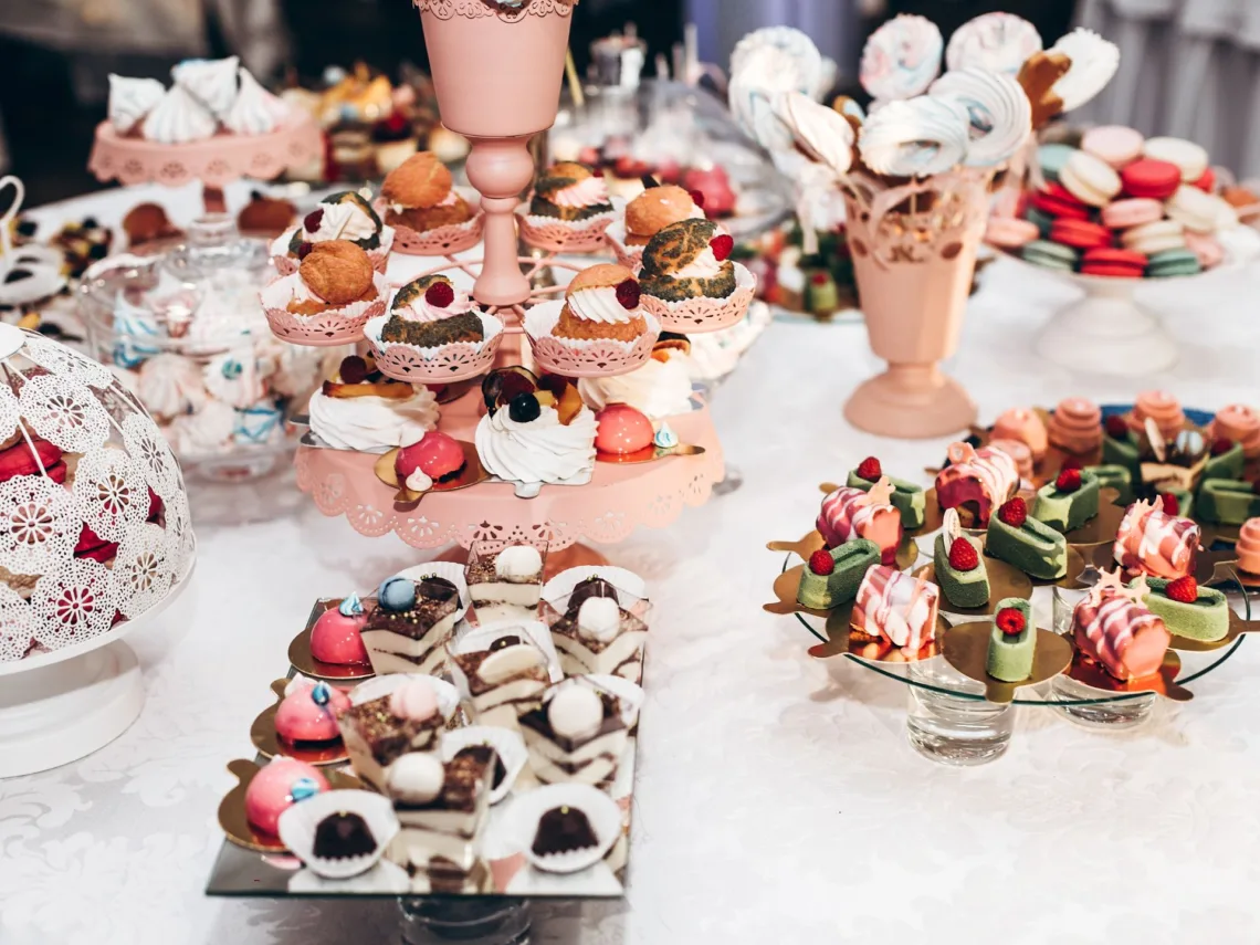 A table filled with a variety of finger foods and desserts.