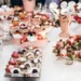 A table filled with a variety of finger foods and desserts.