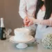 A bride and groom cutting a wedding cake.