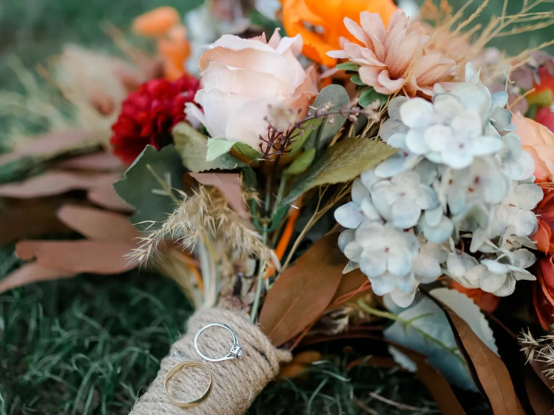A rustic orange and red wedding bouquet.