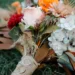 A rustic orange and red wedding bouquet.