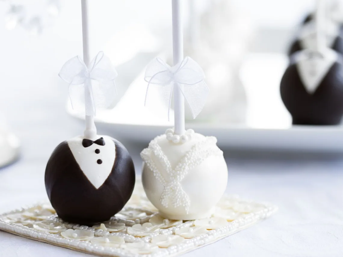 A table with white and black cake pops.