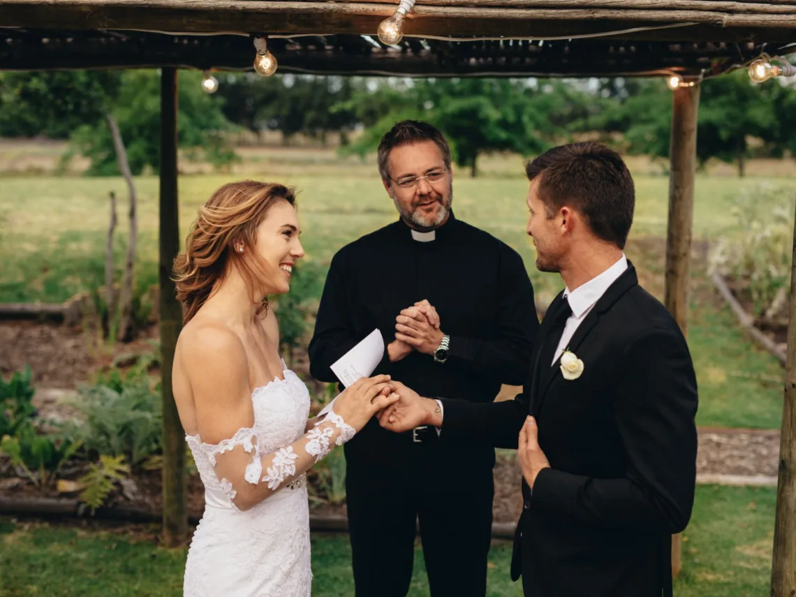 A bride and groom at an outdoor wedding.